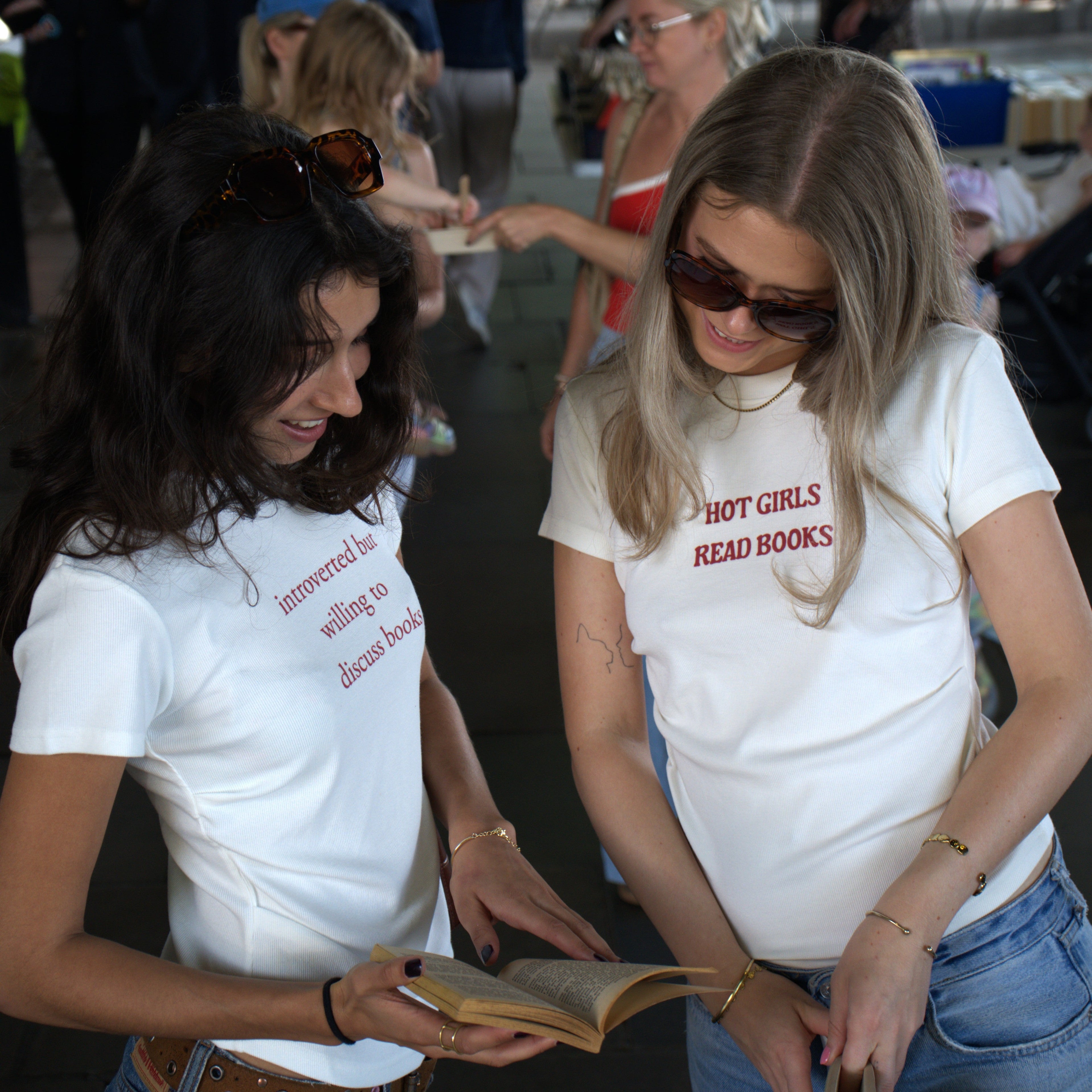 two girls looking at books