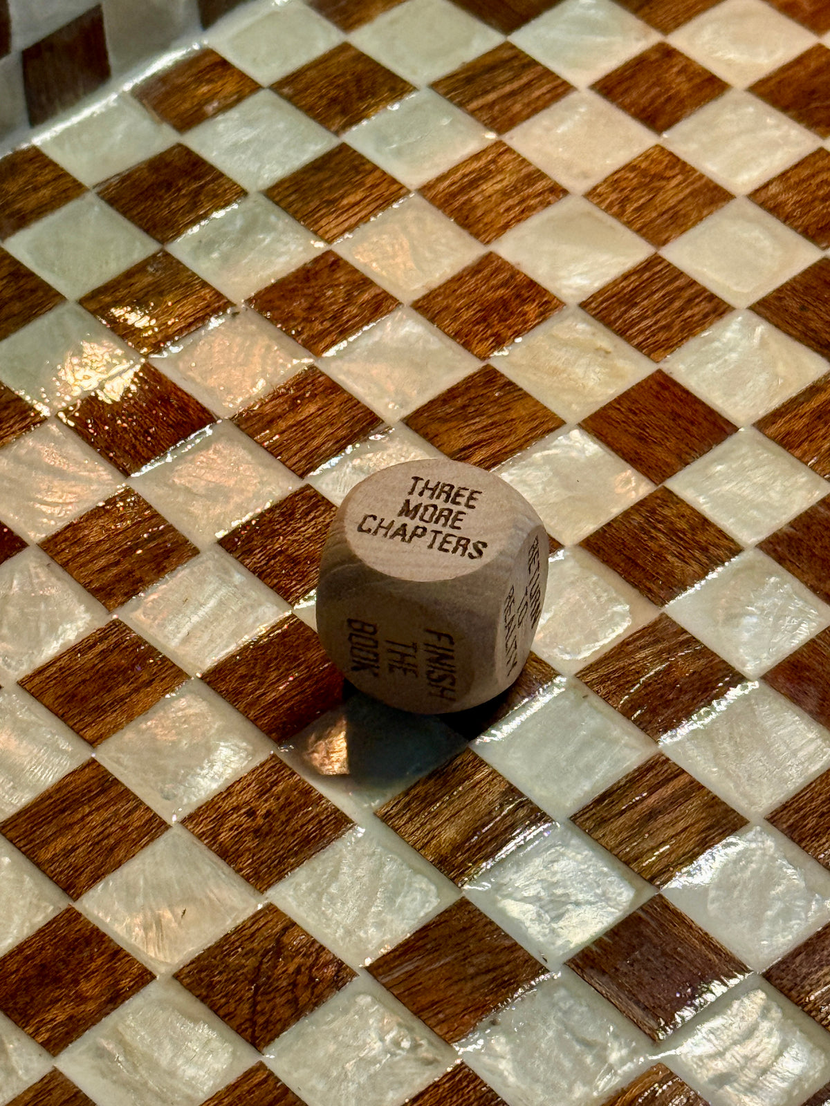 Wooden Reading Decision Die showing the Three More Chapters reading prompt.