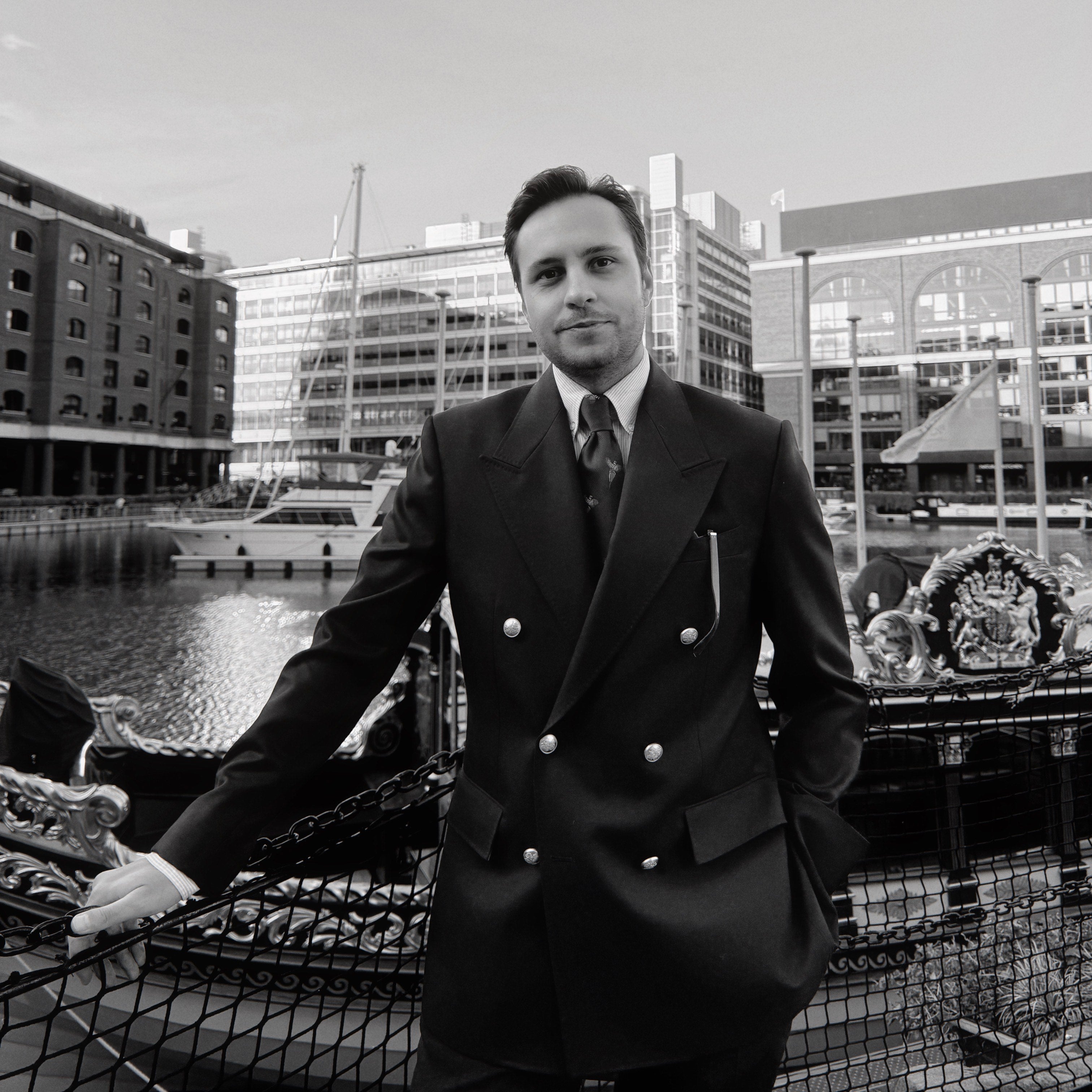 Author Alex Mura, standing at St Katherine Docks