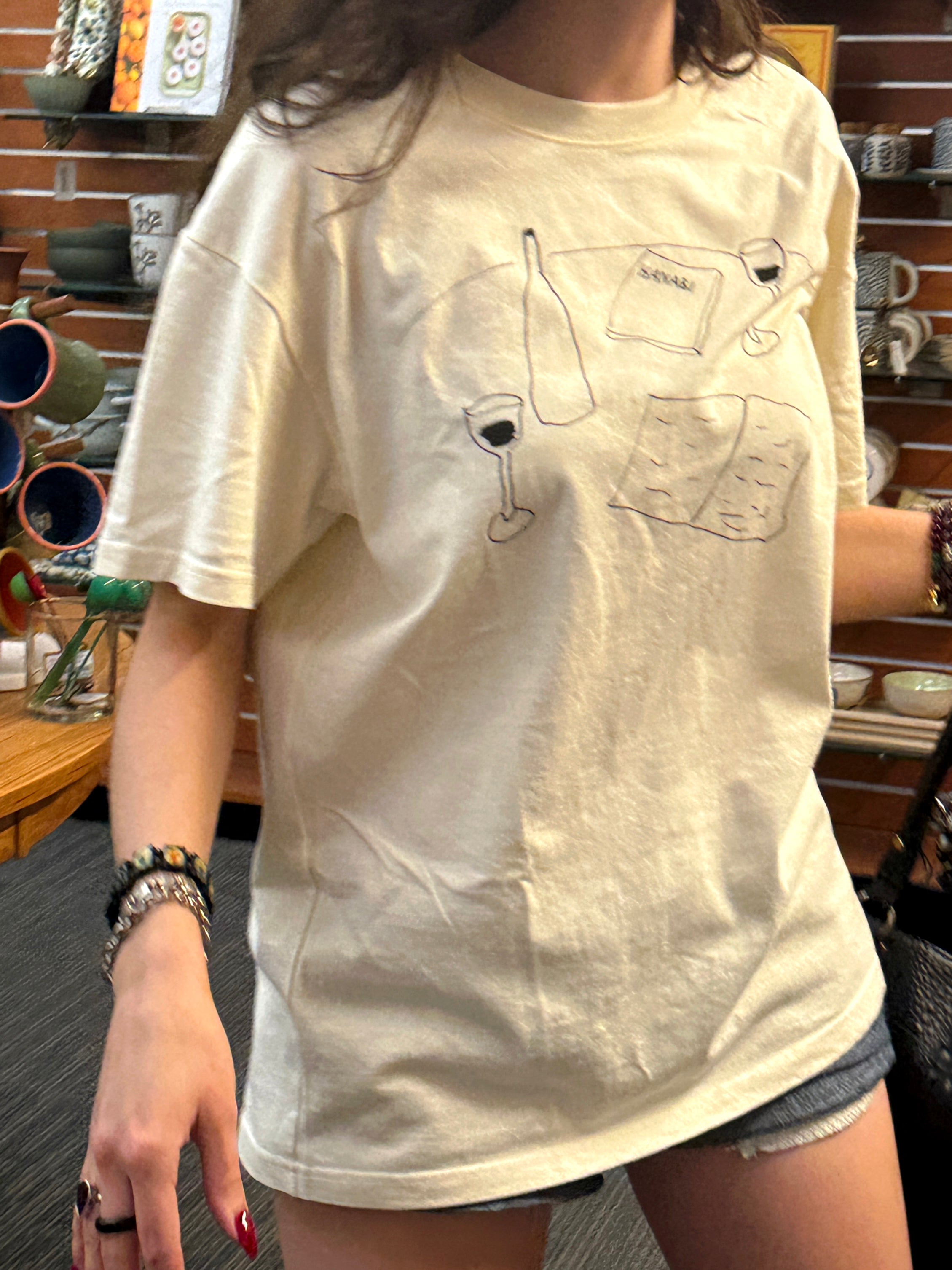 Close-up of the HANABI CLUB “Books and Wine” T-shirt design.