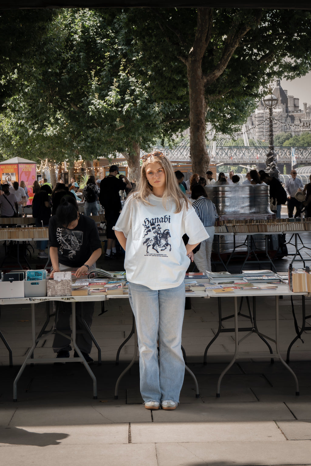 Woman wearing a Hanabi bookish graphic t-shirt